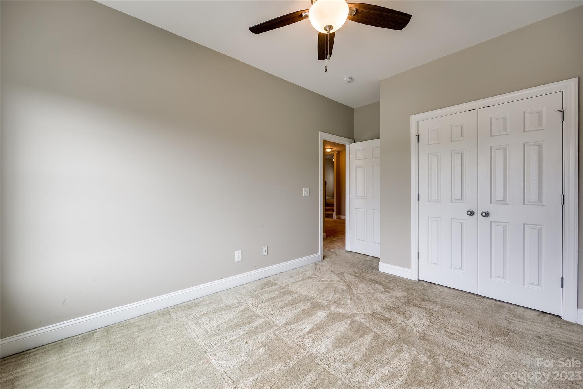 4142 Sunset Ridge Drive, Unit 117 Rock Hill, SC 29732 - Photo 26 of 48 an empty room with chandelier fan and closet