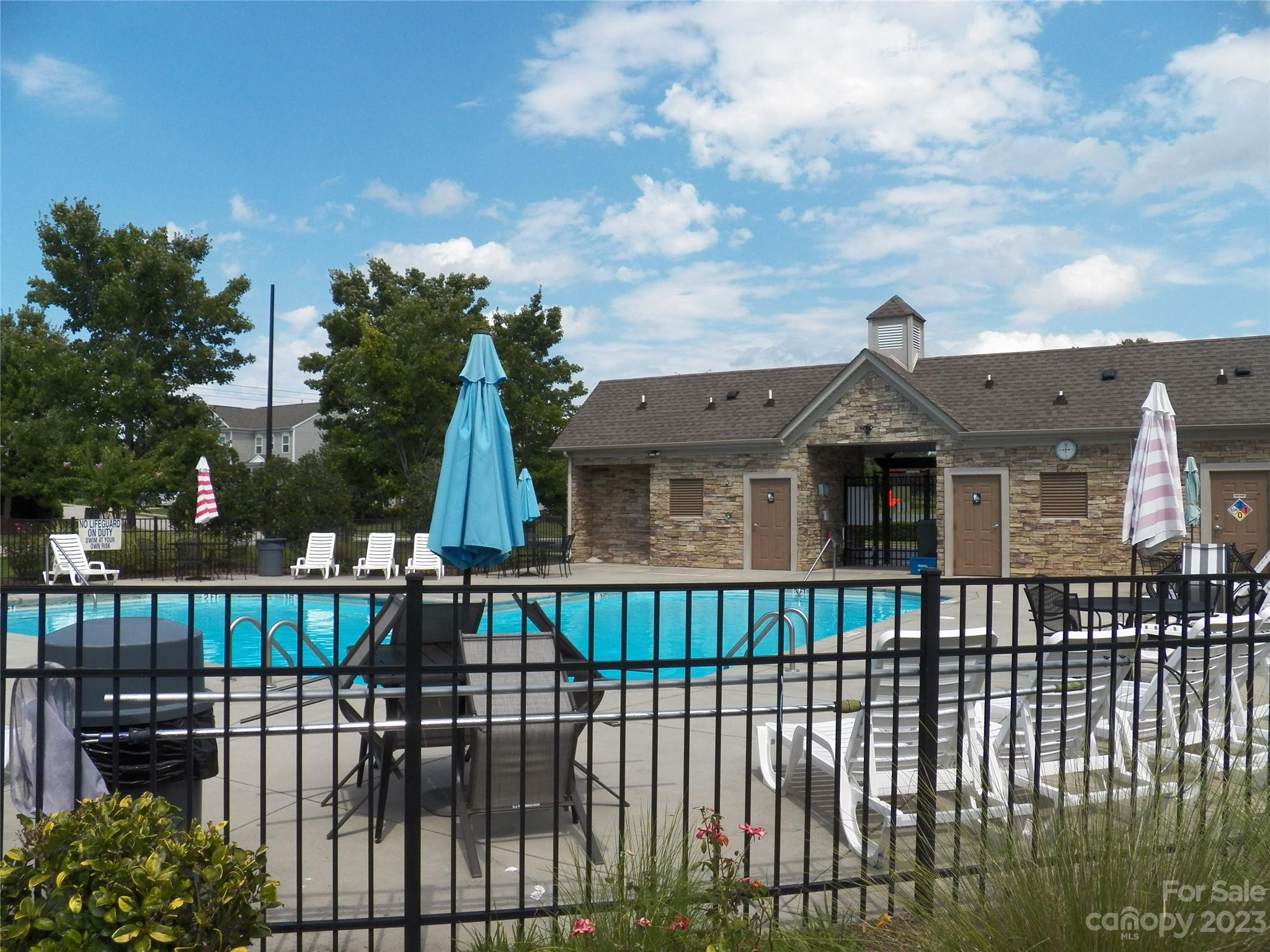 4142 Sunset Ridge Drive, Unit 117 Rock Hill, SC 29732 - Photo 46 of 48 a view of a brick house with large windows and a flower plants