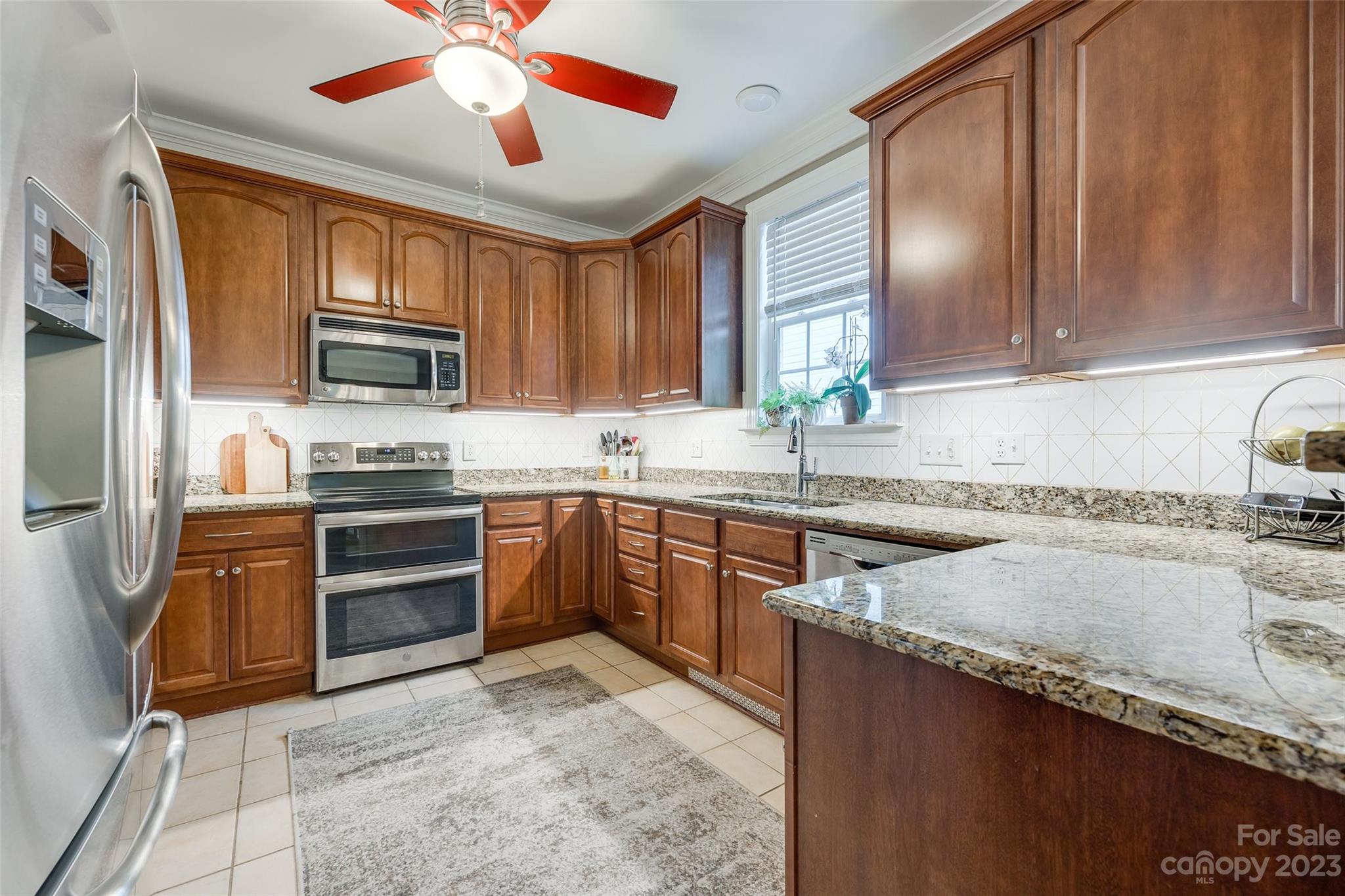 4142 Sunset Ridge Drive, Unit 117 Rock Hill, SC 29732 - Photo 8 of 48 a kitchen with granite countertop a stove sink and microwave