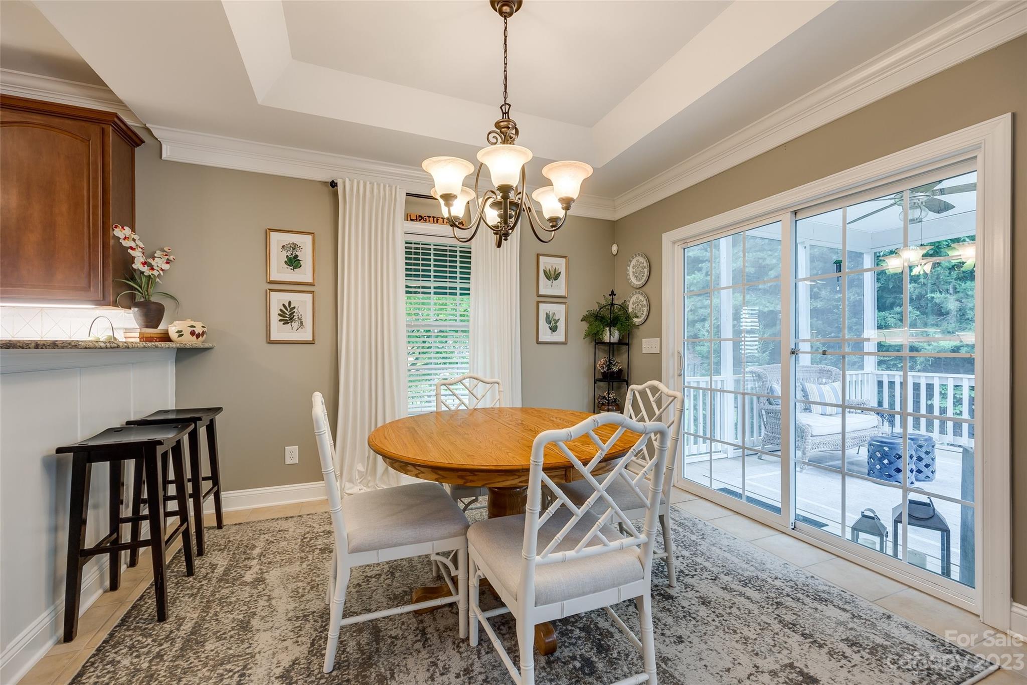 4142 Sunset Ridge Drive, Unit 117 Rock Hill, SC 29732 - Photo 9 of 48 a dining room with furniture a chandelier and window