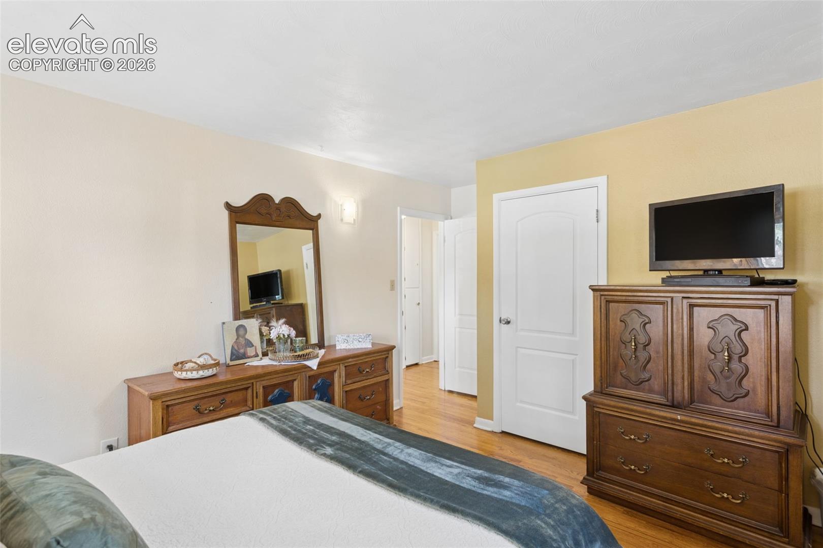 4004 Mallow Road Colorado Springs, CO 80907 - Photo 25 of 50 Wood-finish flooring, white interior doors with curved paneling, and an overhead lighting fixture
