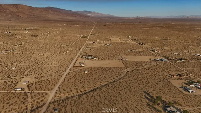 a view of an ocean beach and mountain