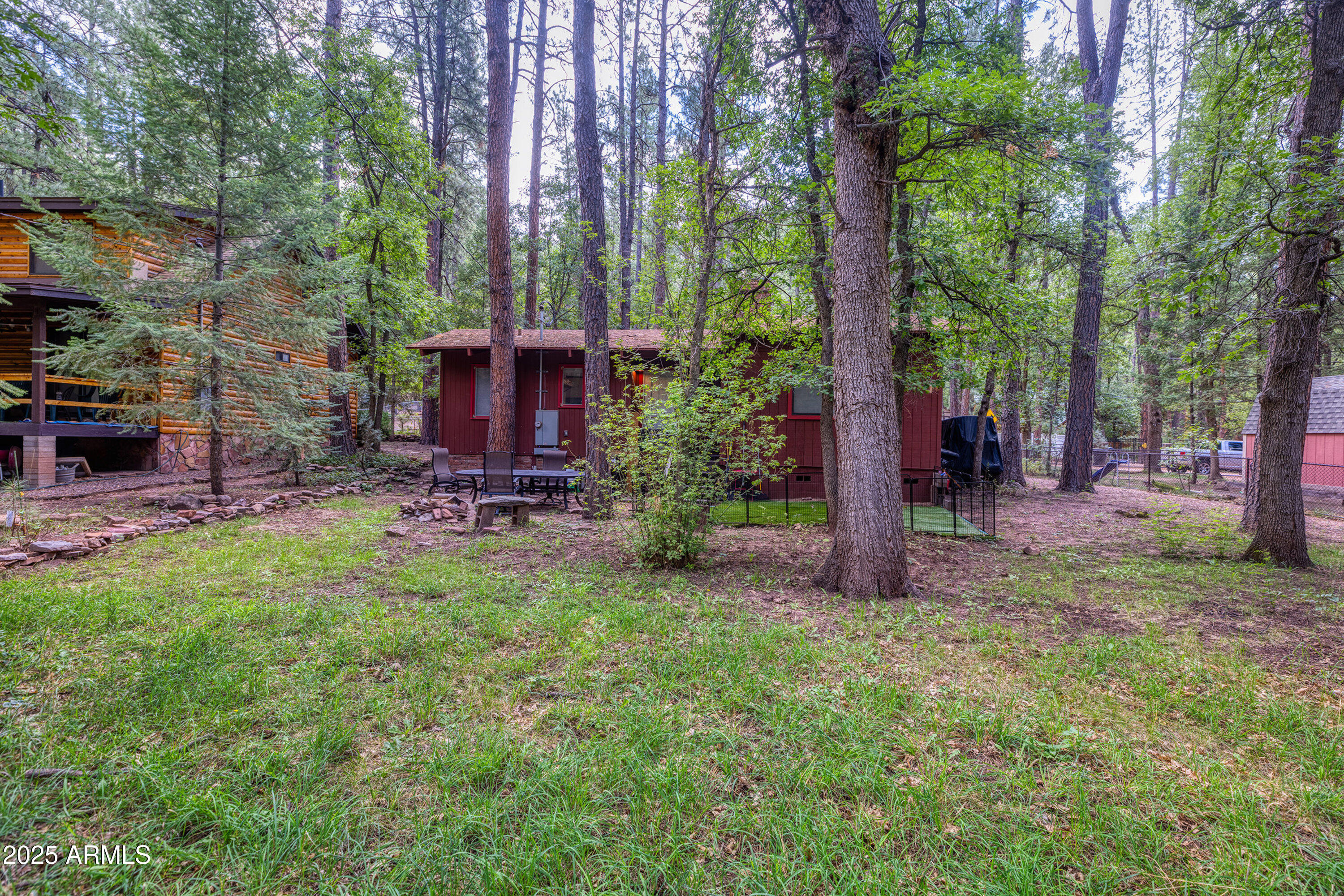 286 West Columbine Road Payson, AZ 85541 - Photo 15 of 17 a view of a backyard with table and chairs potted plants and large tree