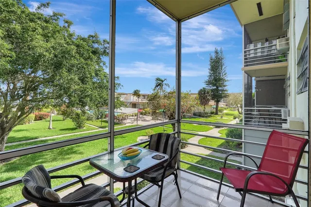 a view of an chairs and tables in the balcony