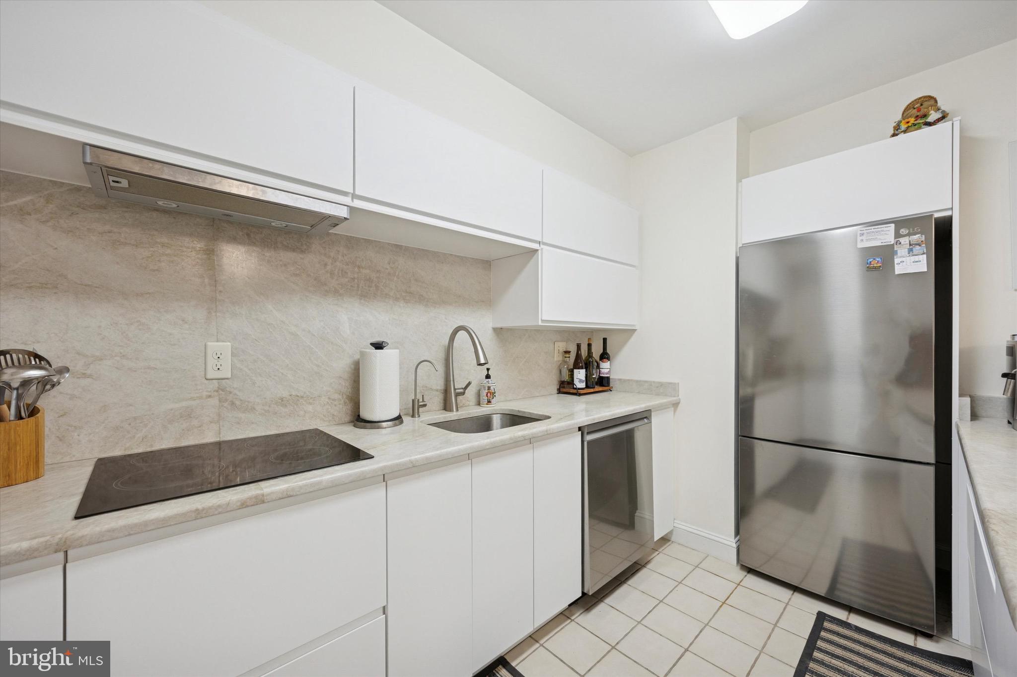 1704 North Park Drive, Unit A409 Wilmington, DE 19806 - Photo 12 of 25 a kitchen with stainless steel appliances a refrigerator and a sink