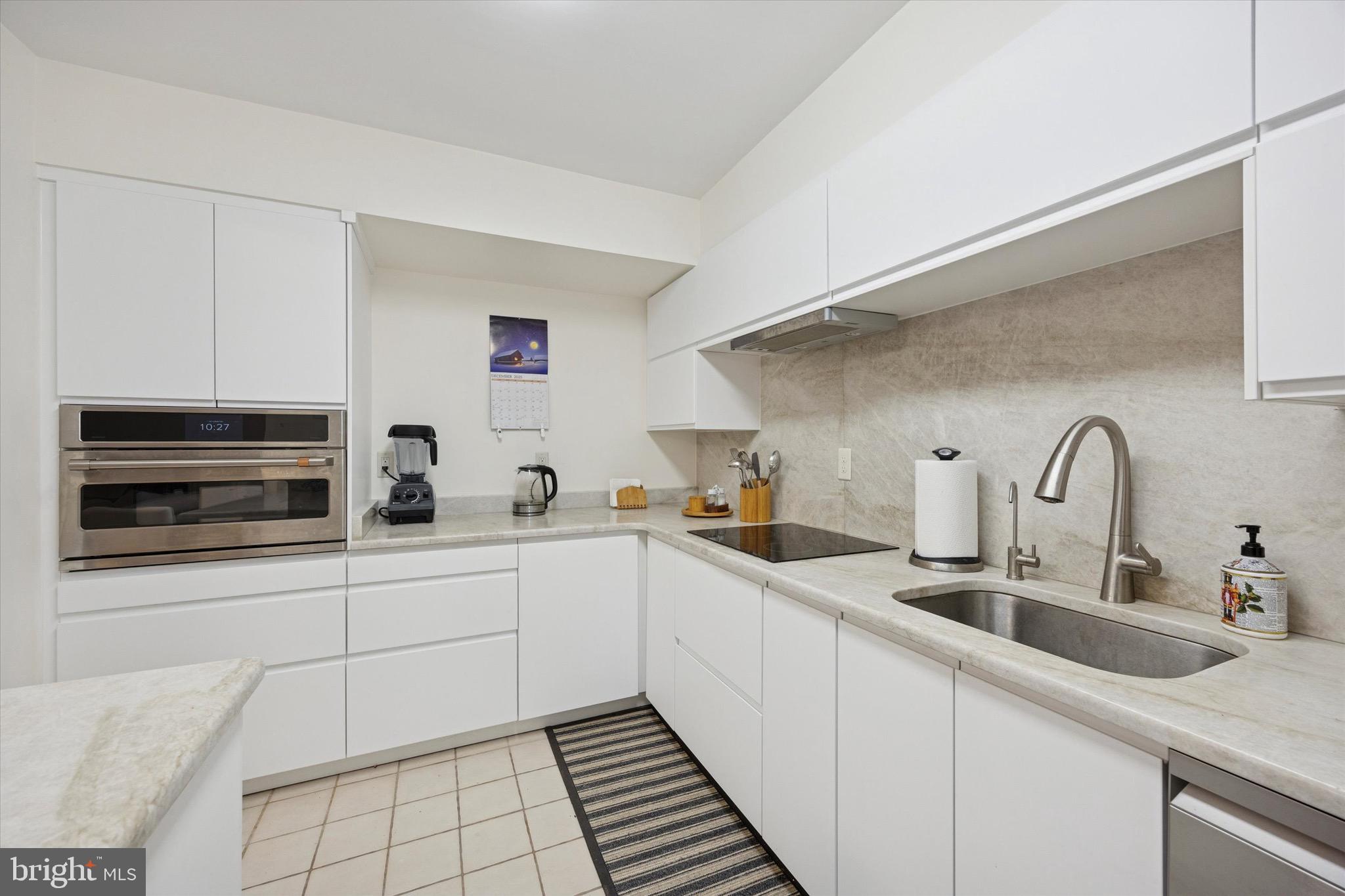 1704 North Park Drive, Unit A409 Wilmington, DE 19806 - Photo 13 of 25 a kitchen with a sink and cabinets