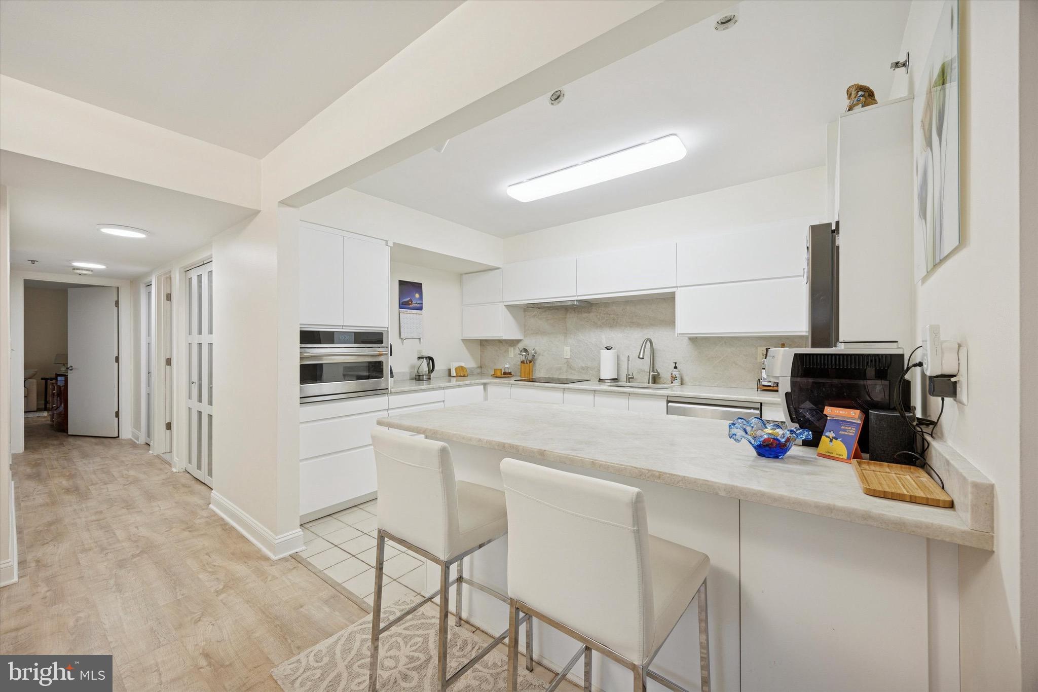 1704 North Park Drive, Unit A409 Wilmington, DE 19806 - Photo 14 of 25 a kitchen with refrigerator and cabinets