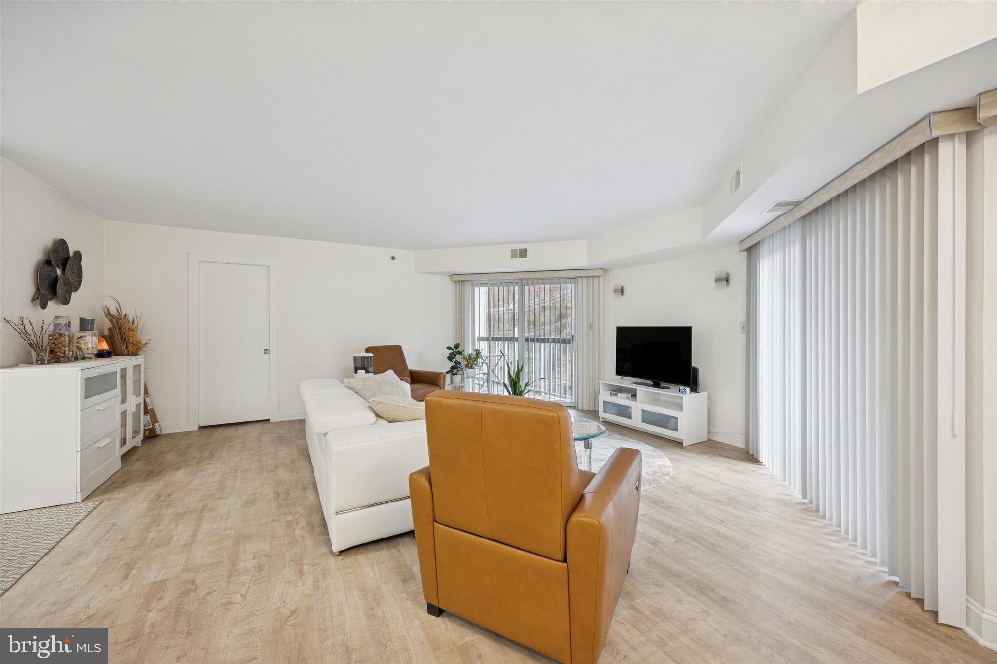 1704 North Park Drive, Unit A409 Wilmington, DE 19806 - Photo 16 of 25 a living room with furniture and a flat screen tv