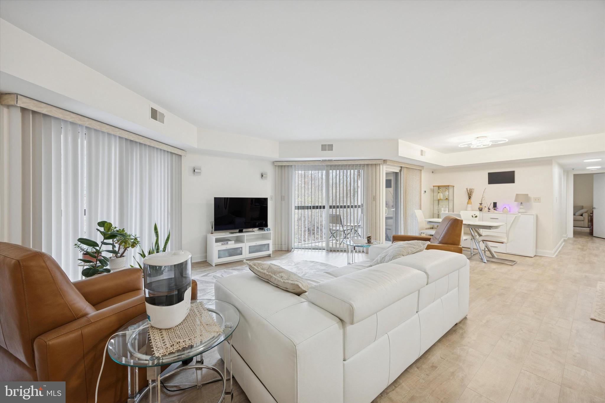 1704 North Park Drive, Unit A409 Wilmington, DE 19806 - Photo 17 of 25 a living room with furniture and a flat screen tv