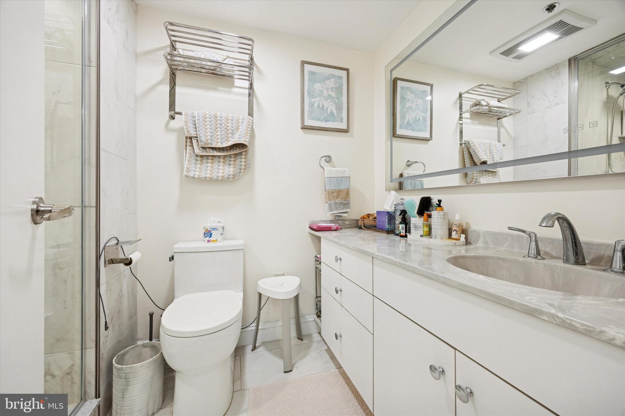 1704 North Park Drive, Unit A409 Wilmington, DE 19806 - Photo 2 of 25 a bathroom with a granite countertop toilet sink and mirror