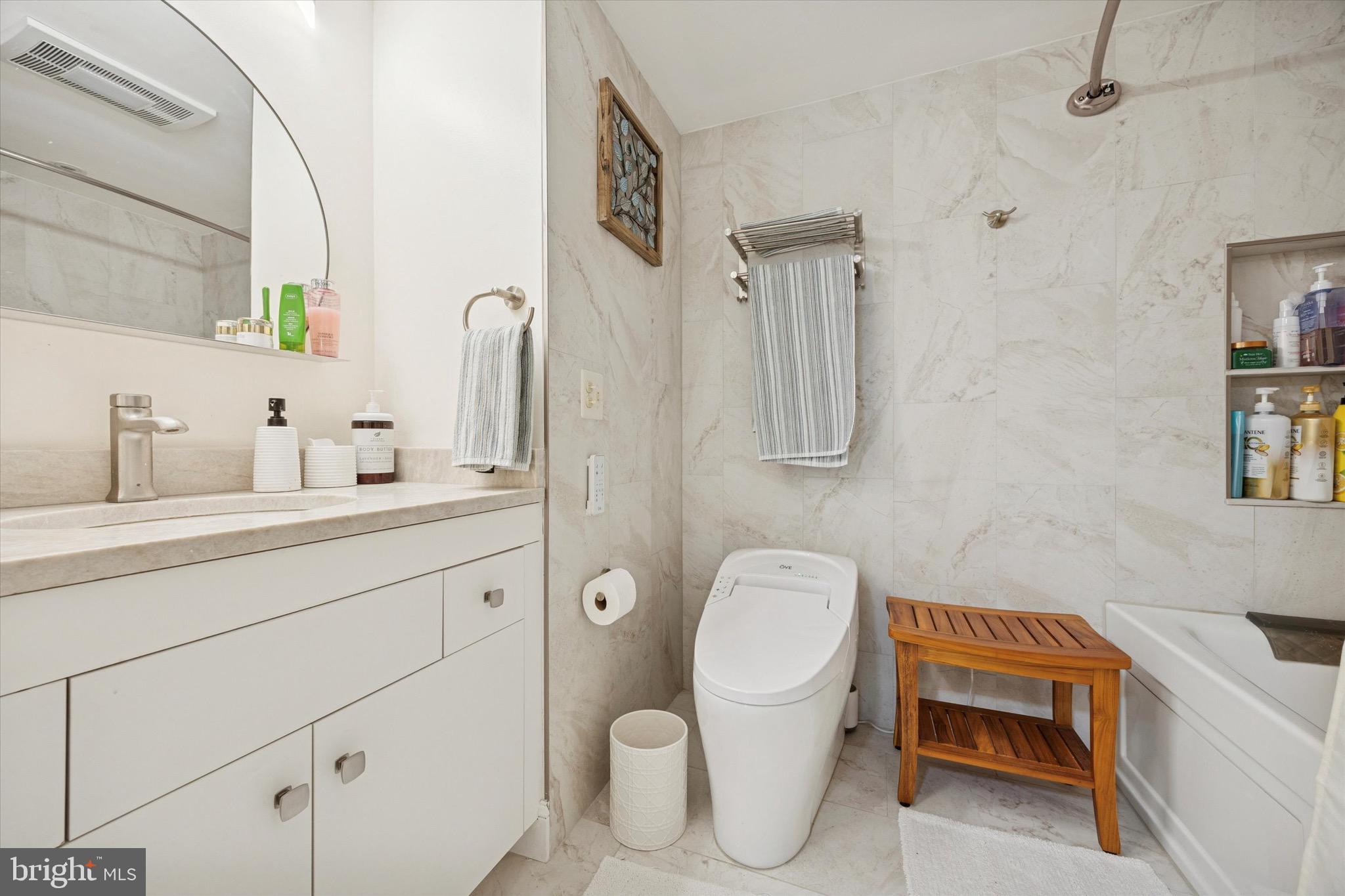 1704 North Park Drive, Unit A409 Wilmington, DE 19806 - Photo 7 of 25 a bathroom with a toilet sink and mirror