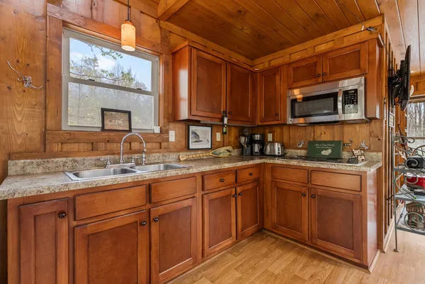 a kitchen with a sink stove and cabinets