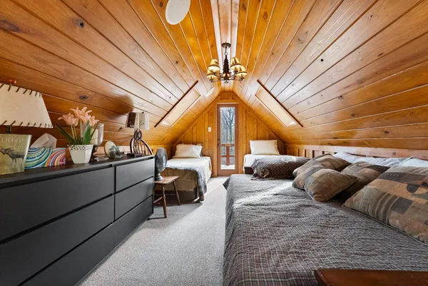 a bedroom with furniture and a chandelier