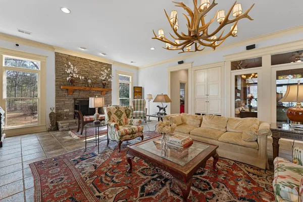 a living room with furniture a large window and a rug