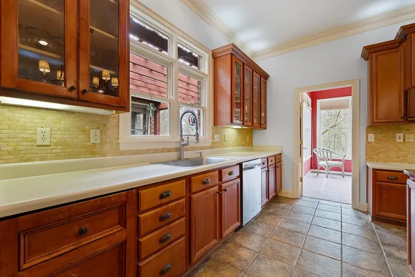 a large kitchen with stainless steel appliances granite countertop a sink and cabinets