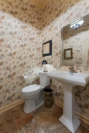 a bathroom with a sink toilet and mirror