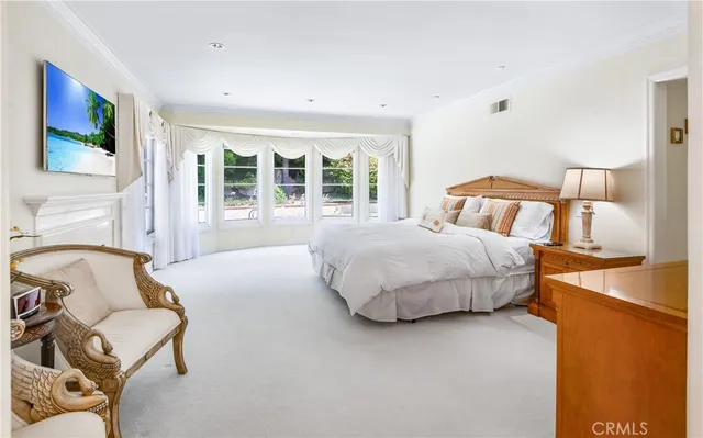 a bedroom with a bed and glass window