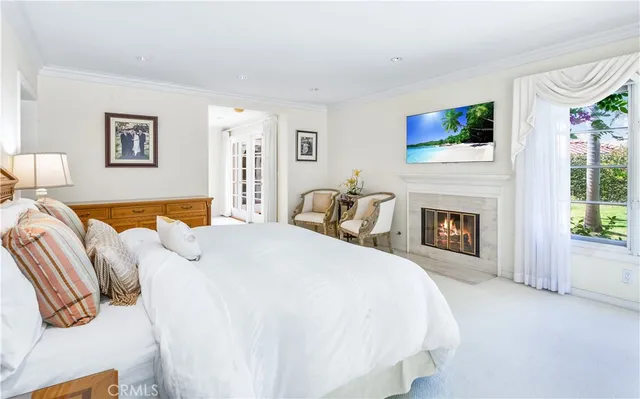 a spacious bedroom with a bed and a fireplace