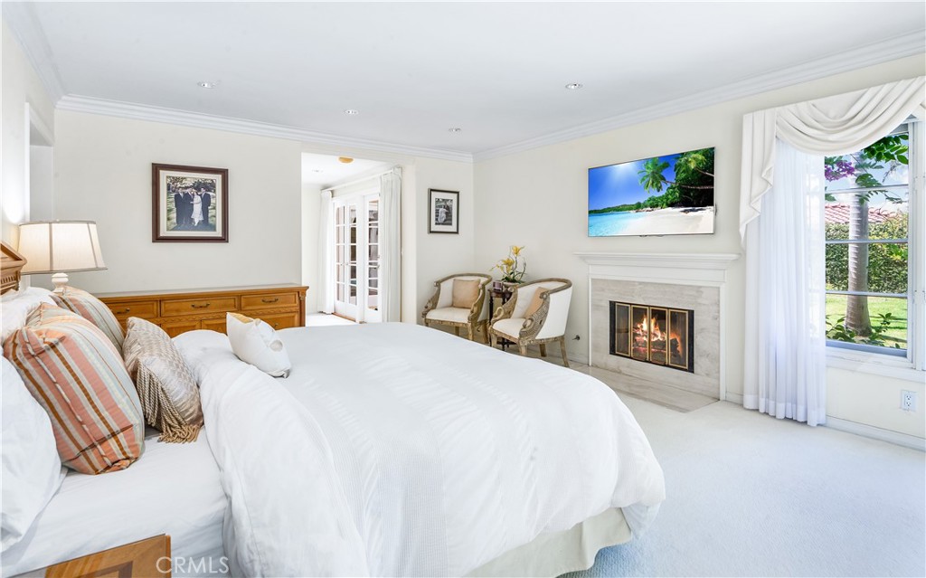 29 Santa Barbara Drive Rancho Palos Verdes, CA 90275 - Photo 13 of 17 a spacious bedroom with a bed and a fireplace