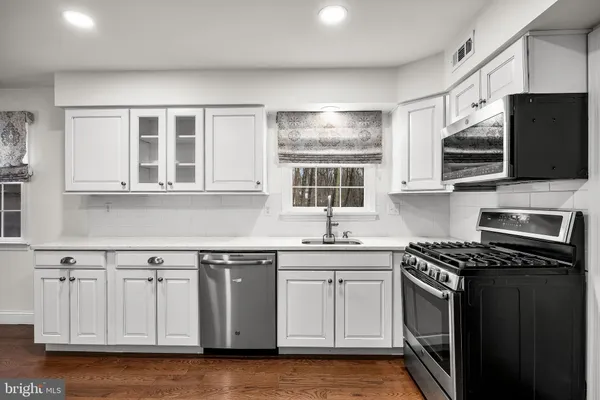 a kitchen with stainless steel appliances granite countertop a stove and a sink