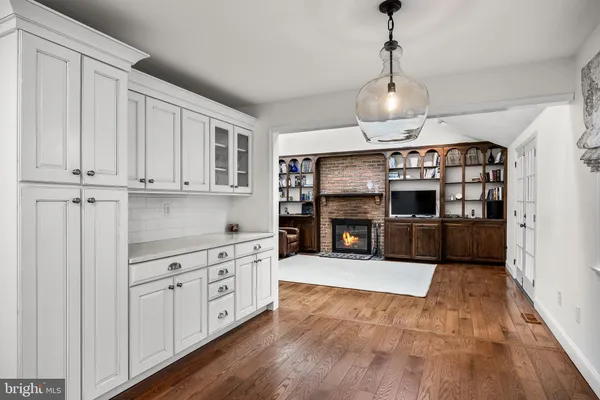 a large kitchen with stainless steel appliances granite countertop a stove and a sink with cabinets