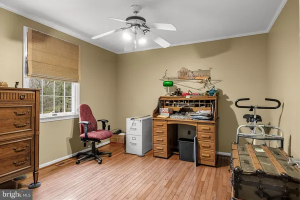 a view of a workspace with furniture and a dresser