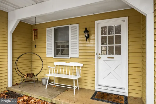 a backyard of a house with barbeque and wooden fence