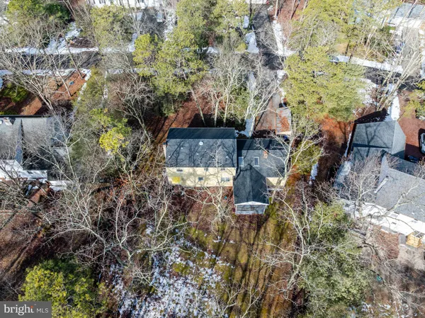 a aerial view of a house with yard and street view