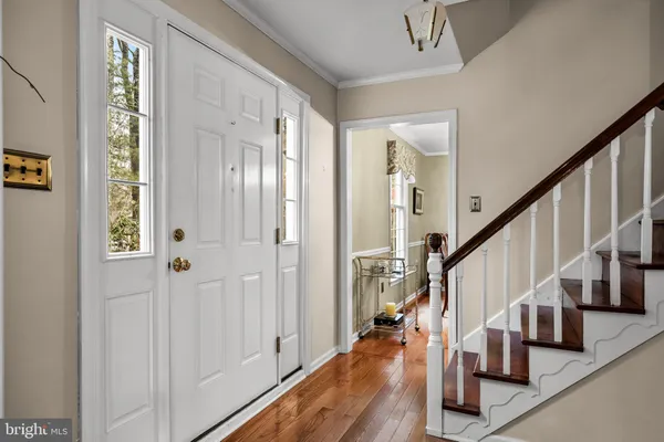 a view of entryway with wooden floor and stairs
