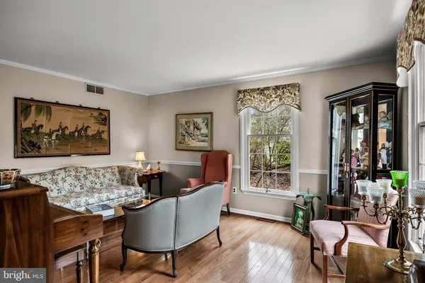 a living room with furniture and floor to ceiling window