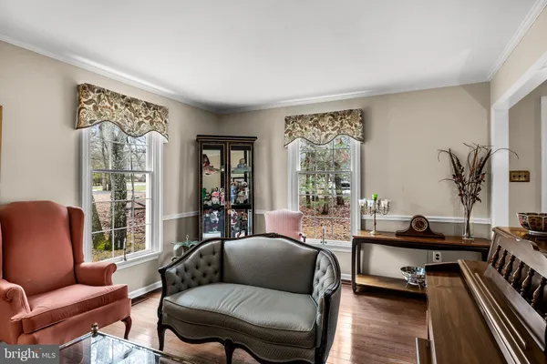 a living room with furniture fireplace and a large window