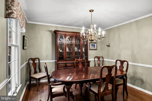 a view of a dining room with furniture and chandelier