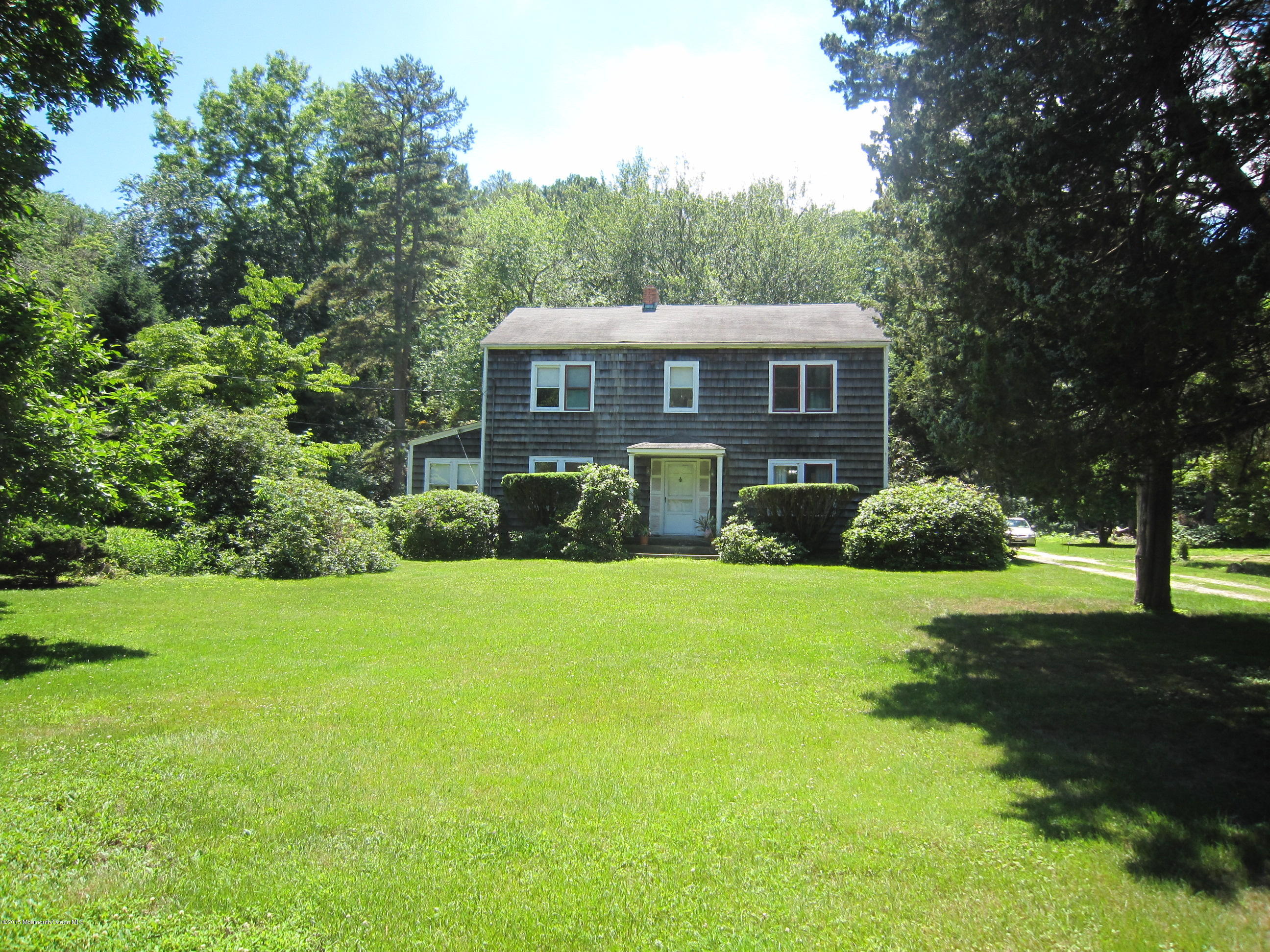 482 Brickyard Road Freehold, NJ 07728 - Photo 1 of 17 a view of a big yard with plants and large trees