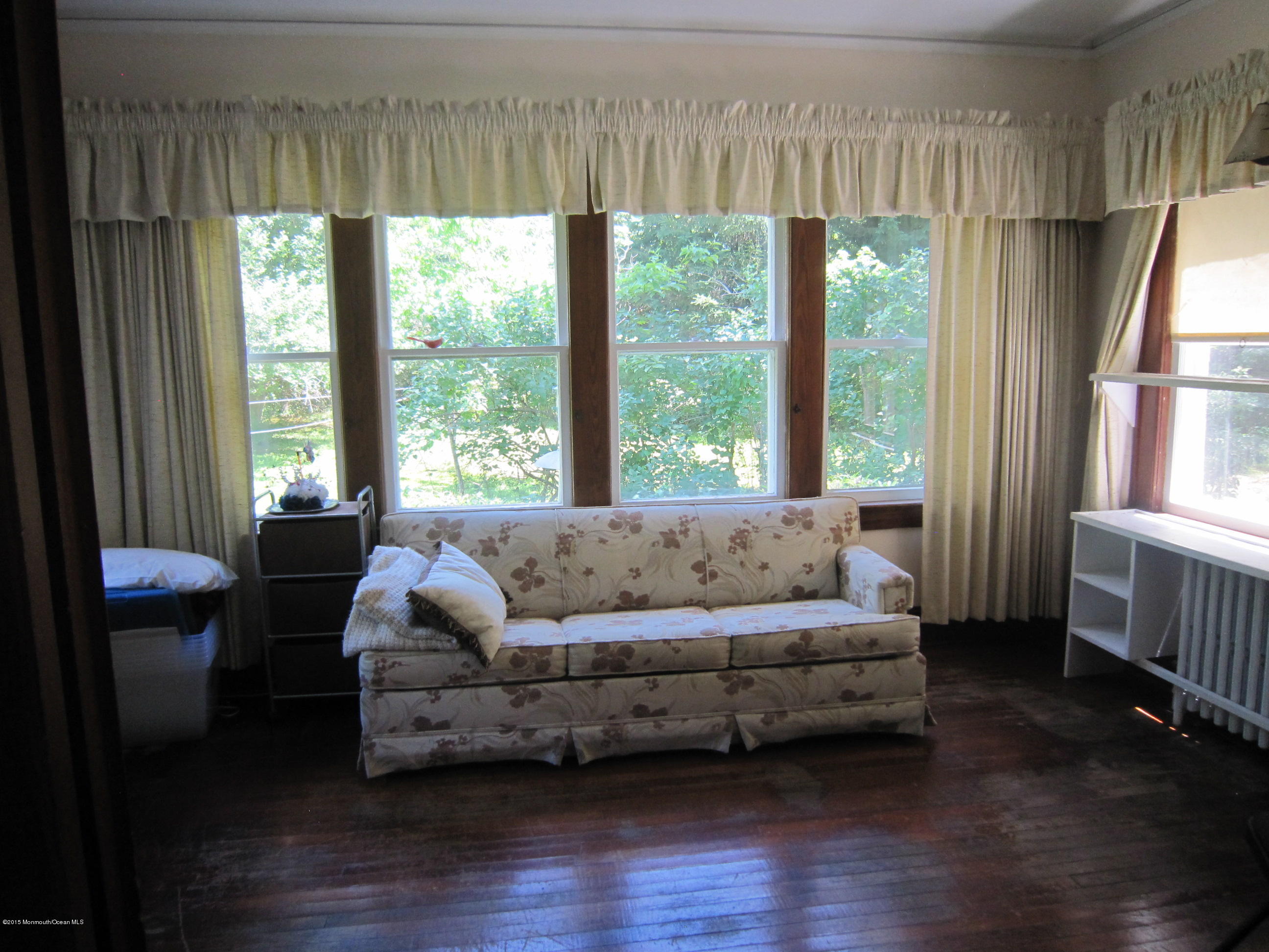 482 Brickyard Road Freehold, NJ 07728 - Photo 12 of 17 a living room with furniture and a large window