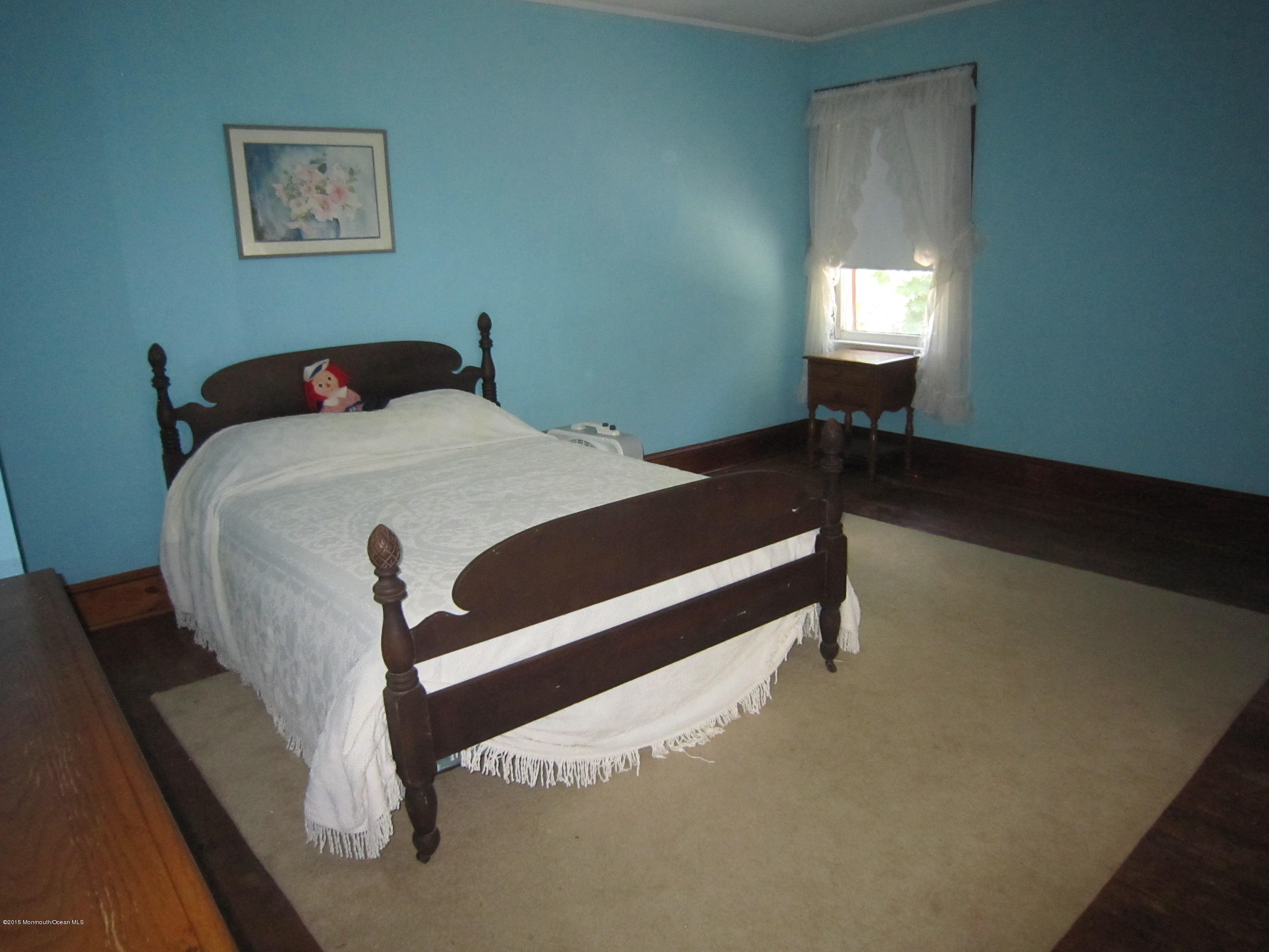 482 Brickyard Road Freehold, NJ 07728 - Photo 16 of 17 a bedroom with a bed and a lamp on table