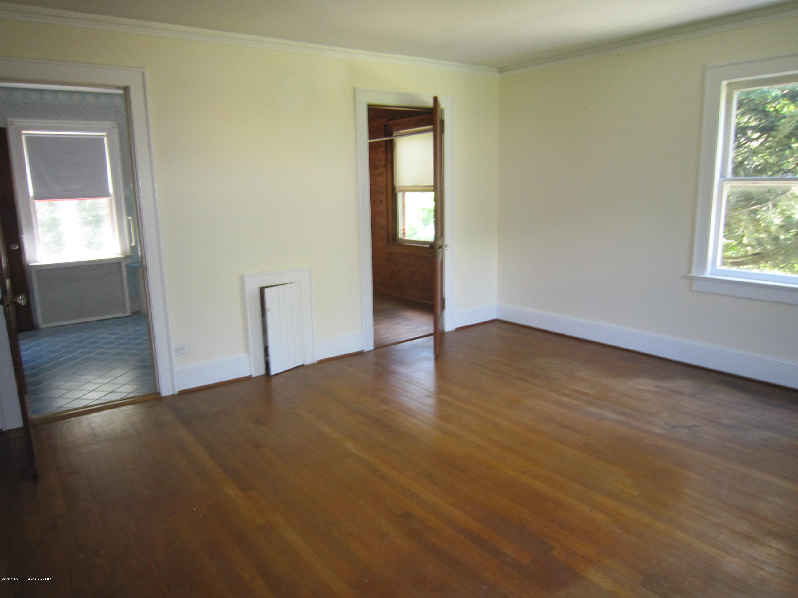 482 Brickyard Road Freehold, NJ 07728 - Photo 17 of 17 an empty room with wooden floor and windows