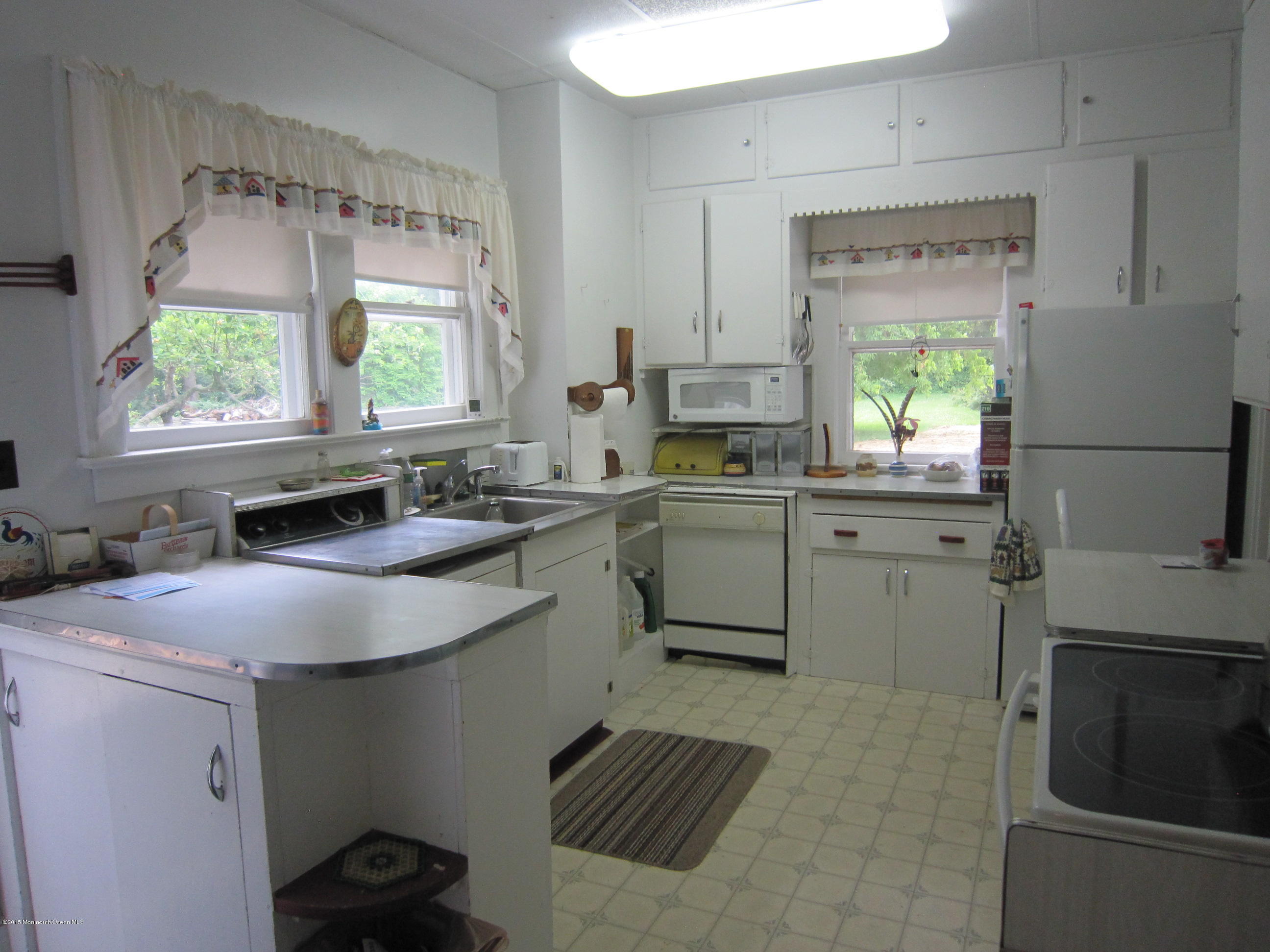 482 Brickyard Road Freehold, NJ 07728 - Photo 2 of 17 a kitchen with a sink appliances cabinets and a window