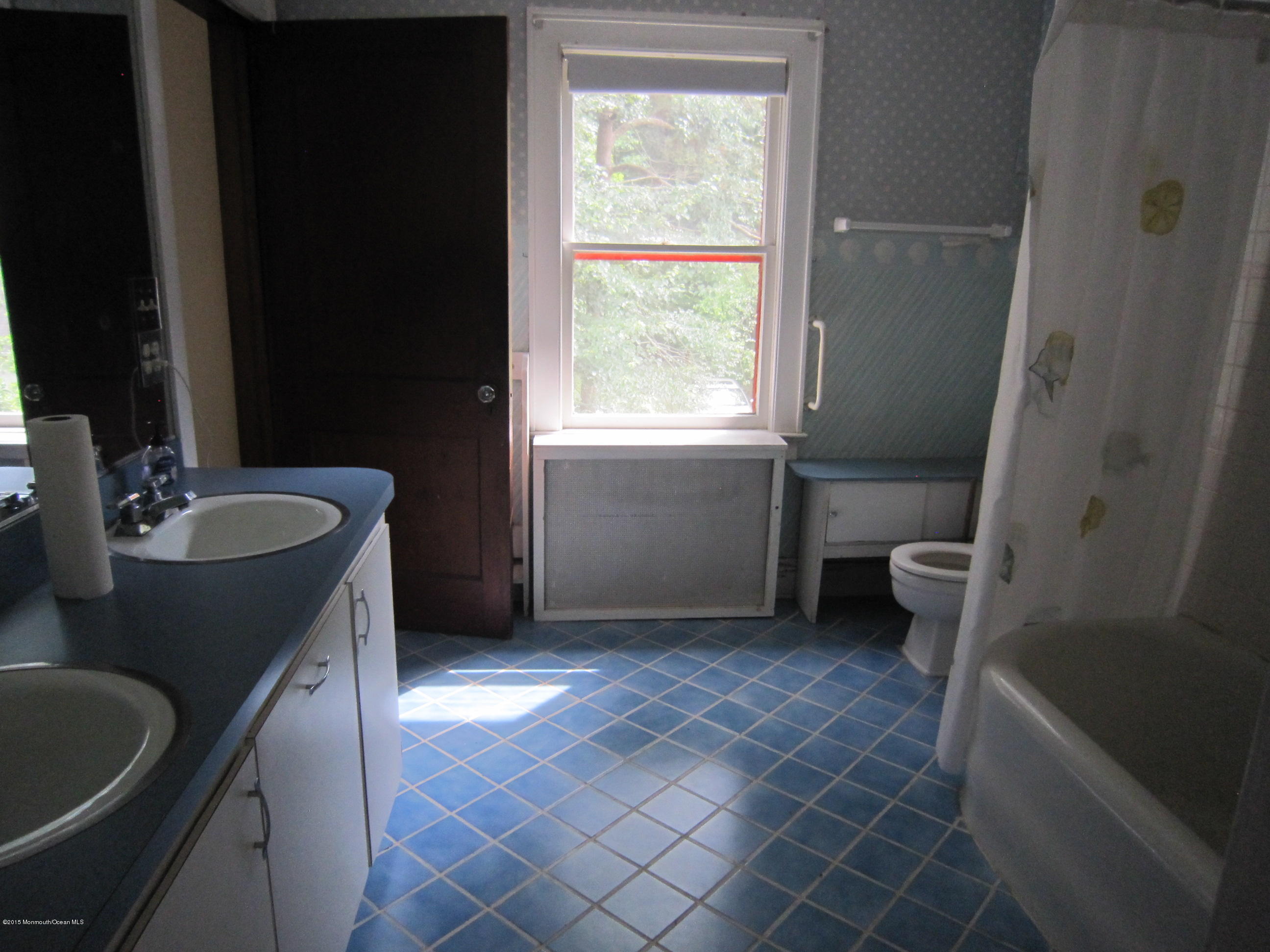 482 Brickyard Road Freehold, NJ 07728 - Photo 4 of 17 a bathroom with a granite countertop sink a toilet a window and a mirror