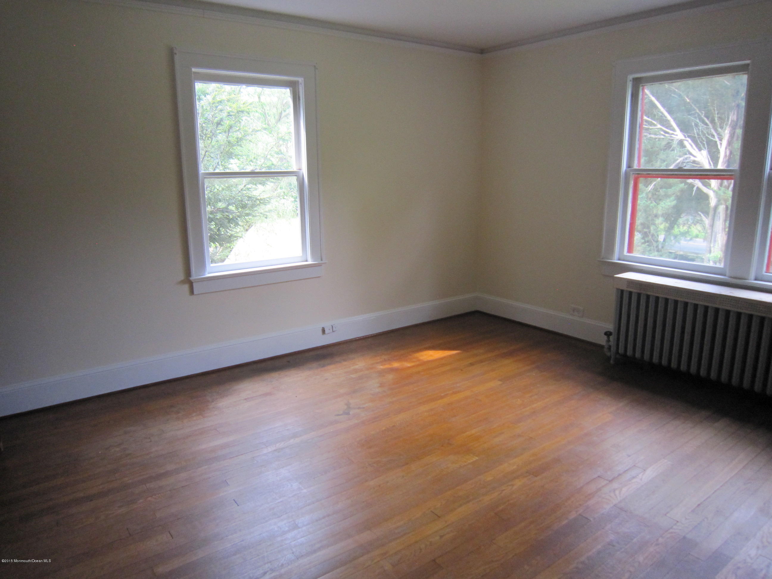 482 Brickyard Road Freehold, NJ 07728 - Photo 5 of 17 an empty room with wooden floor and windows