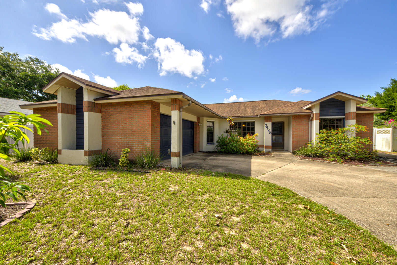 2423 Jaywood Road Titusville, FL 32780 - Photo 1 of 37 a front view of a house with a yard and garage