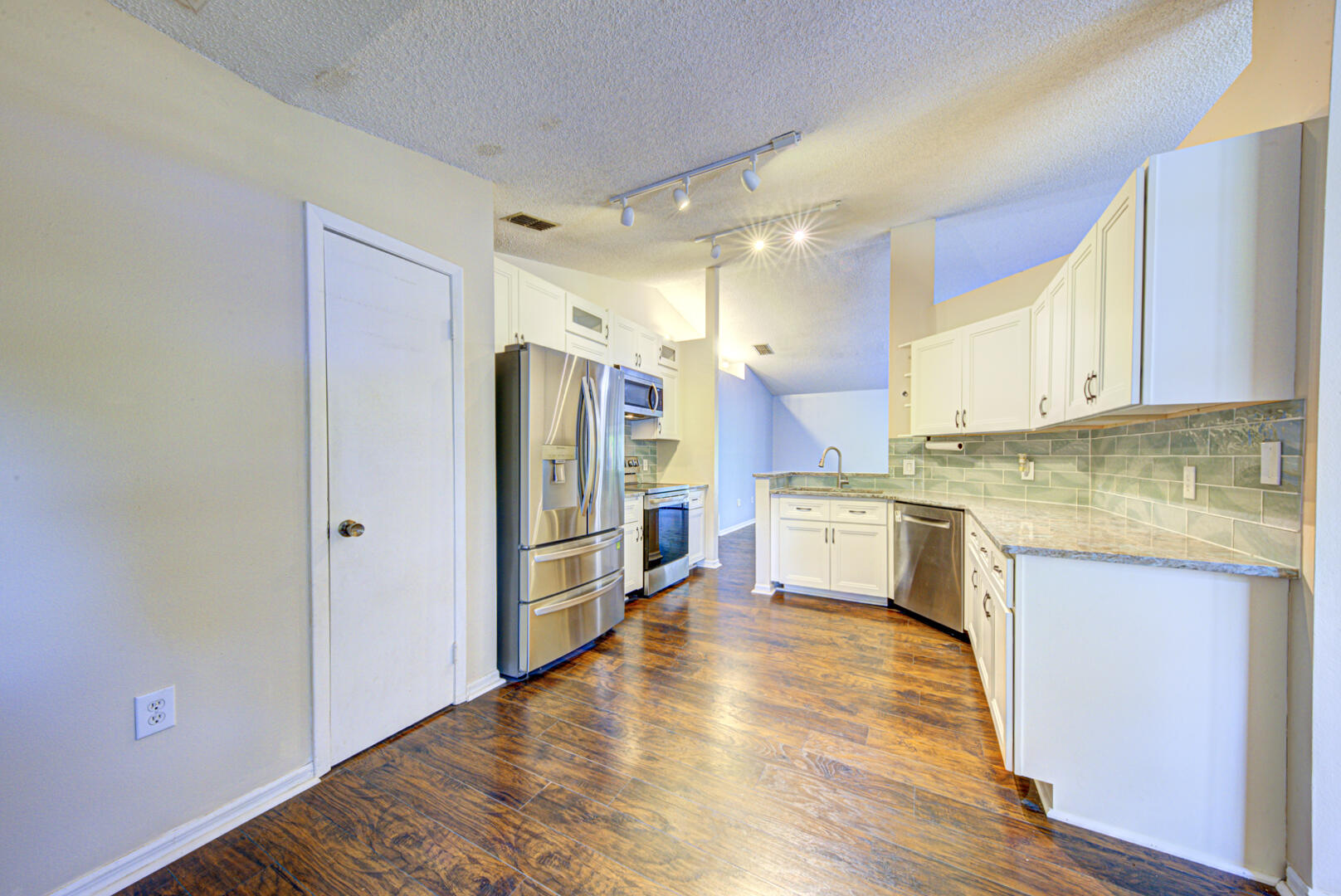 2423 Jaywood Road Titusville, FL 32780 - Photo 11 of 37 a kitchen with stainless steel appliances granite countertop a refrigerator a sink and white cabinets