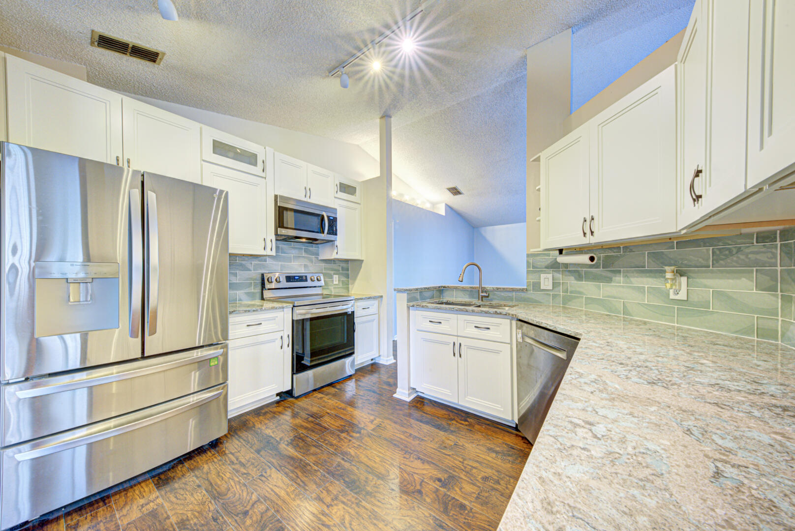2423 Jaywood Road Titusville, FL 32780 - Photo 12 of 37 a kitchen with stainless steel appliances granite countertop a refrigerator a stove and a sink with granite countertops