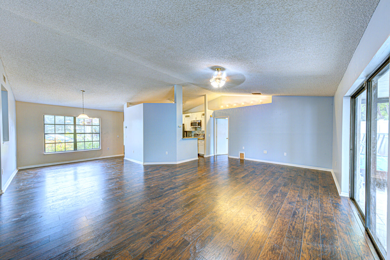 2423 Jaywood Road Titusville, FL 32780 - Photo 17 of 37 an empty room with wooden floor and windows