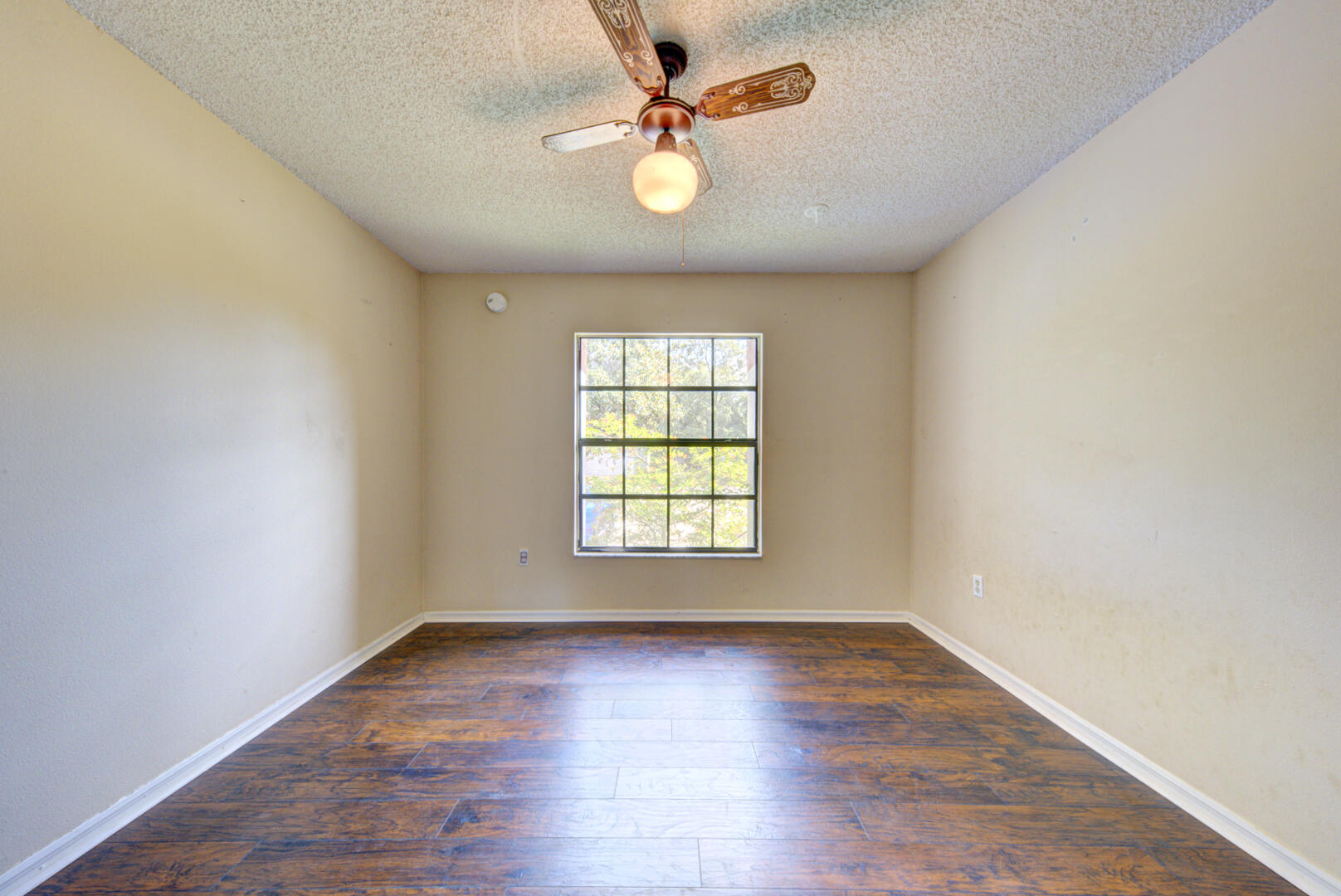 2423 Jaywood Road Titusville, FL 32780 - Photo 22 of 37 an empty room with wooden floor and windows