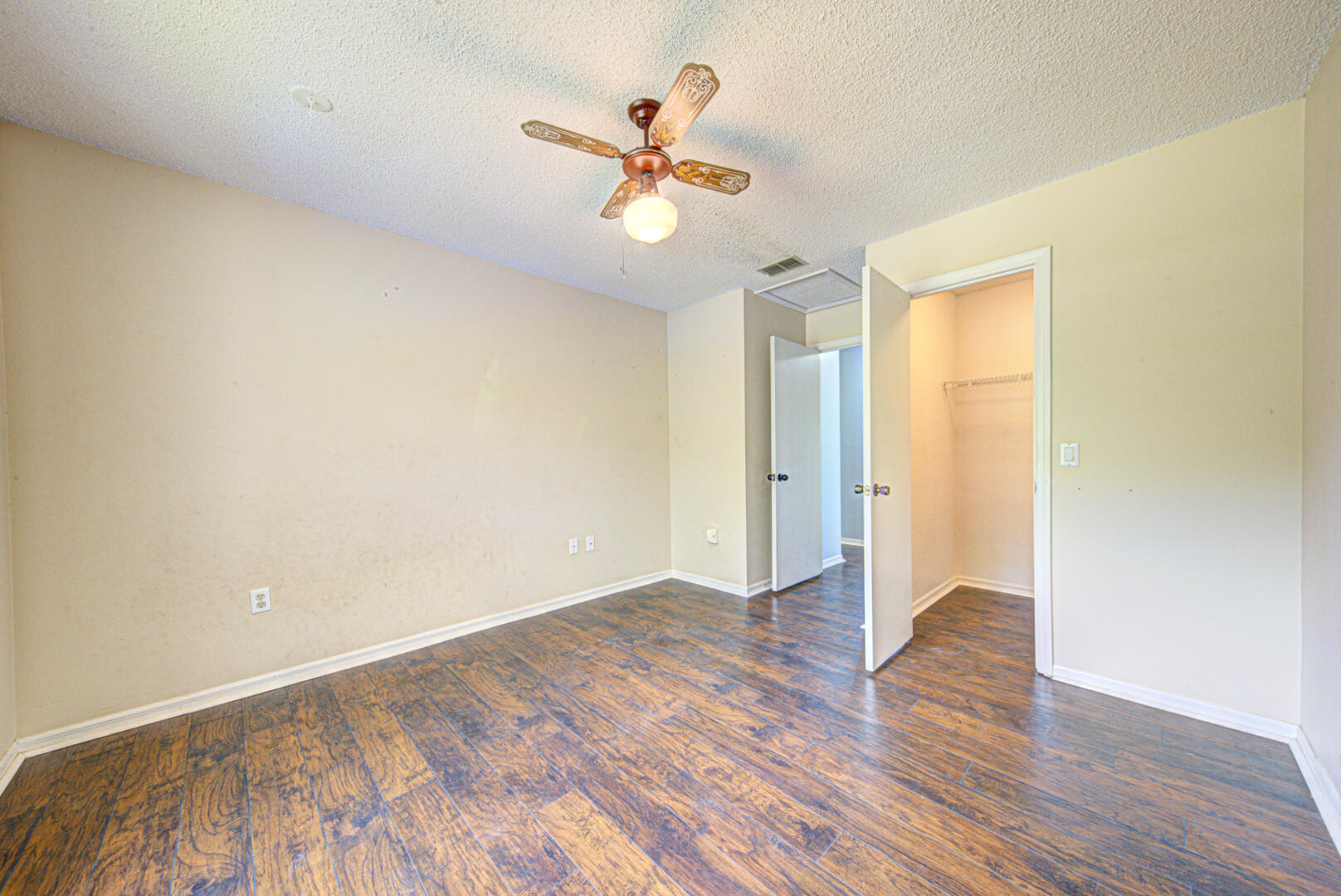 2423 Jaywood Road Titusville, FL 32780 - Photo 23 of 37 an empty room with wooden floor fan and windows