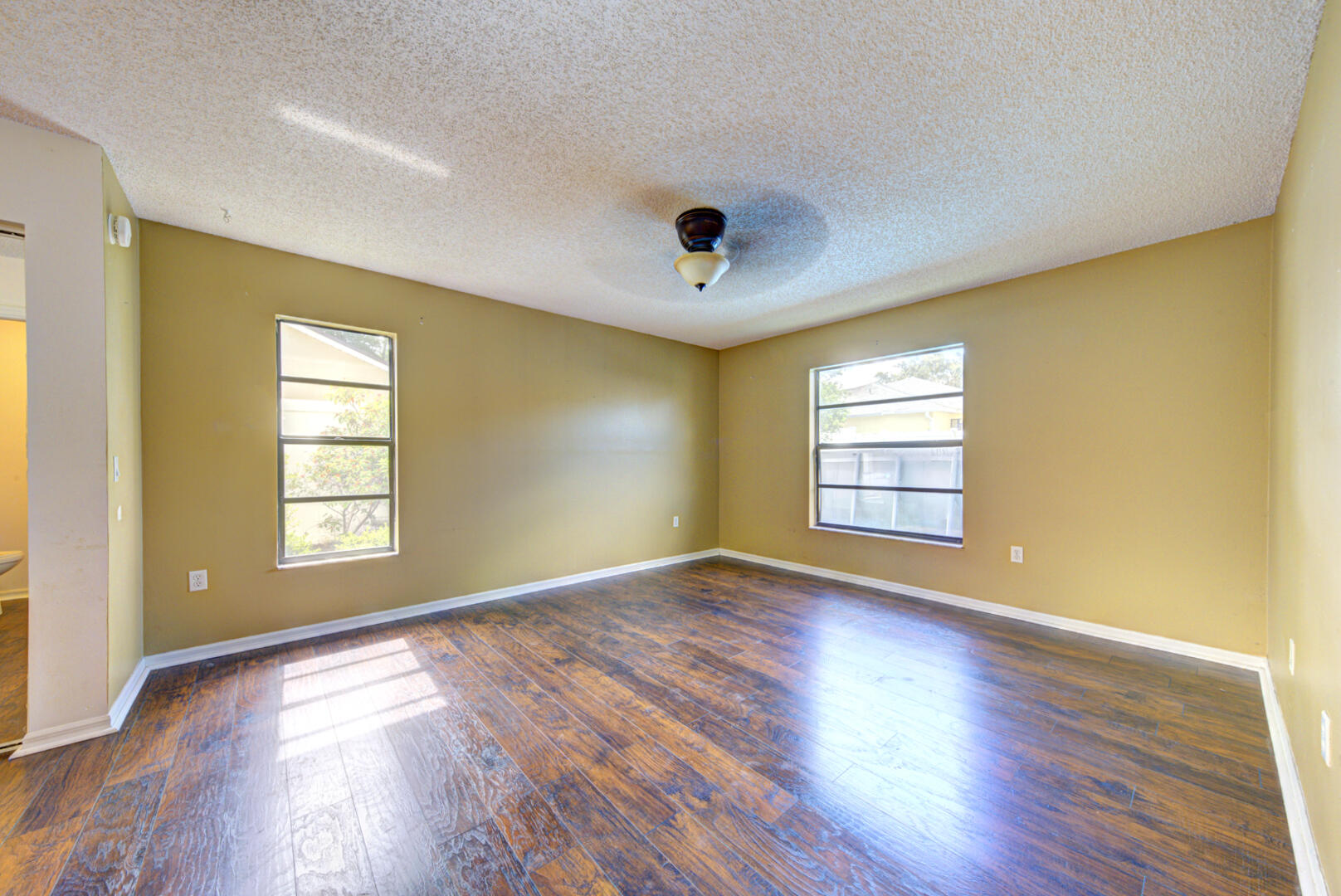 2423 Jaywood Road Titusville, FL 32780 - Photo 24 of 37 a view of an empty room with wooden floor and a window