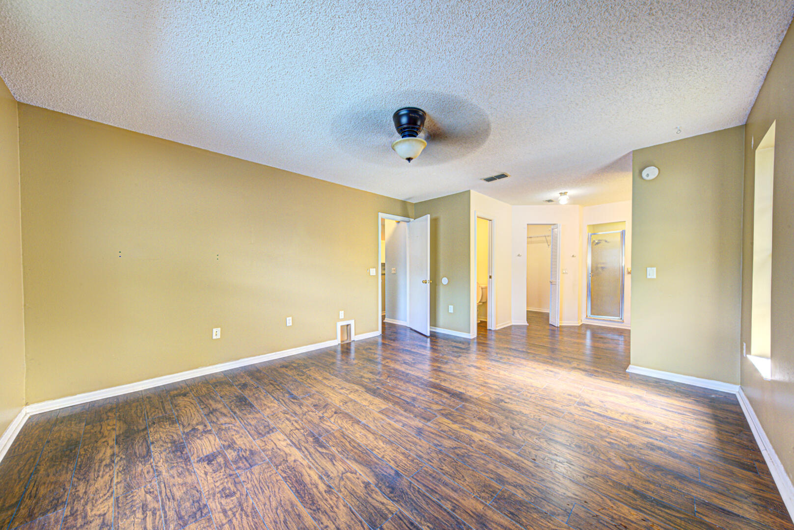 2423 Jaywood Road Titusville, FL 32780 - Photo 26 of 37 a view of an empty room with wooden floor and a window