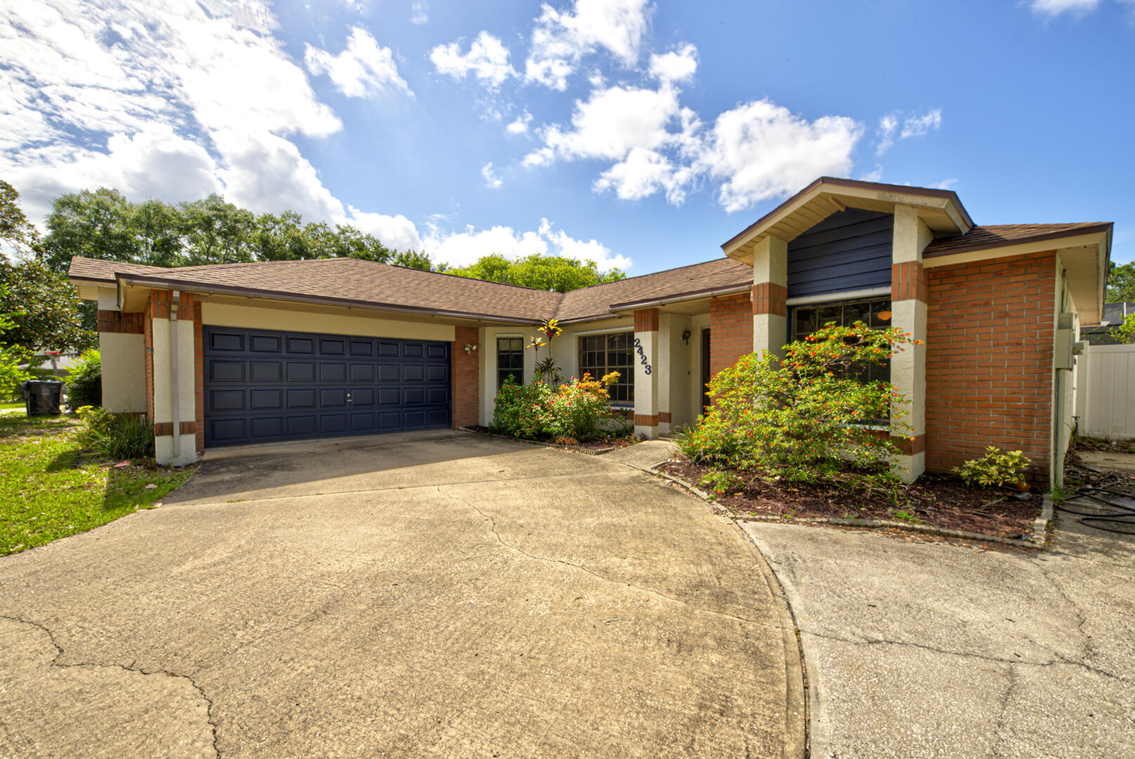 2423 Jaywood Road Titusville, FL 32780 - Photo 3 of 37 a front view of a house with a yard and garage