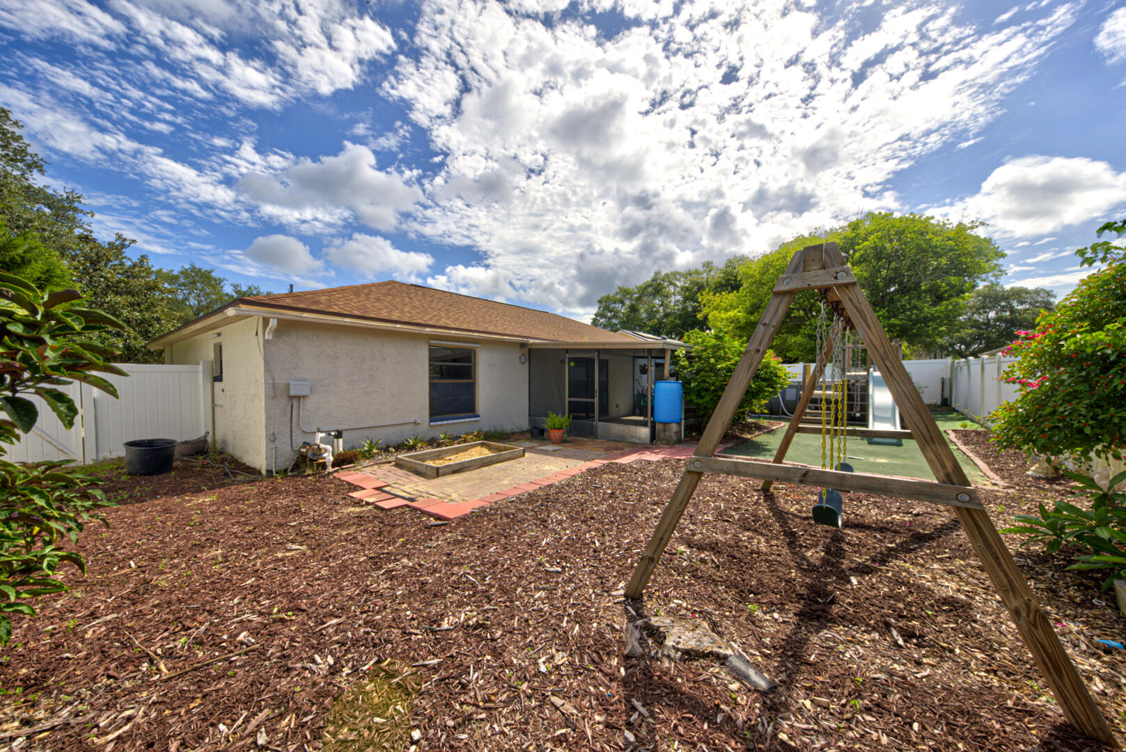 2423 Jaywood Road Titusville, FL 32780 - Photo 33 of 37 a backyard of a house with barbeque oven fire pit table and chairs