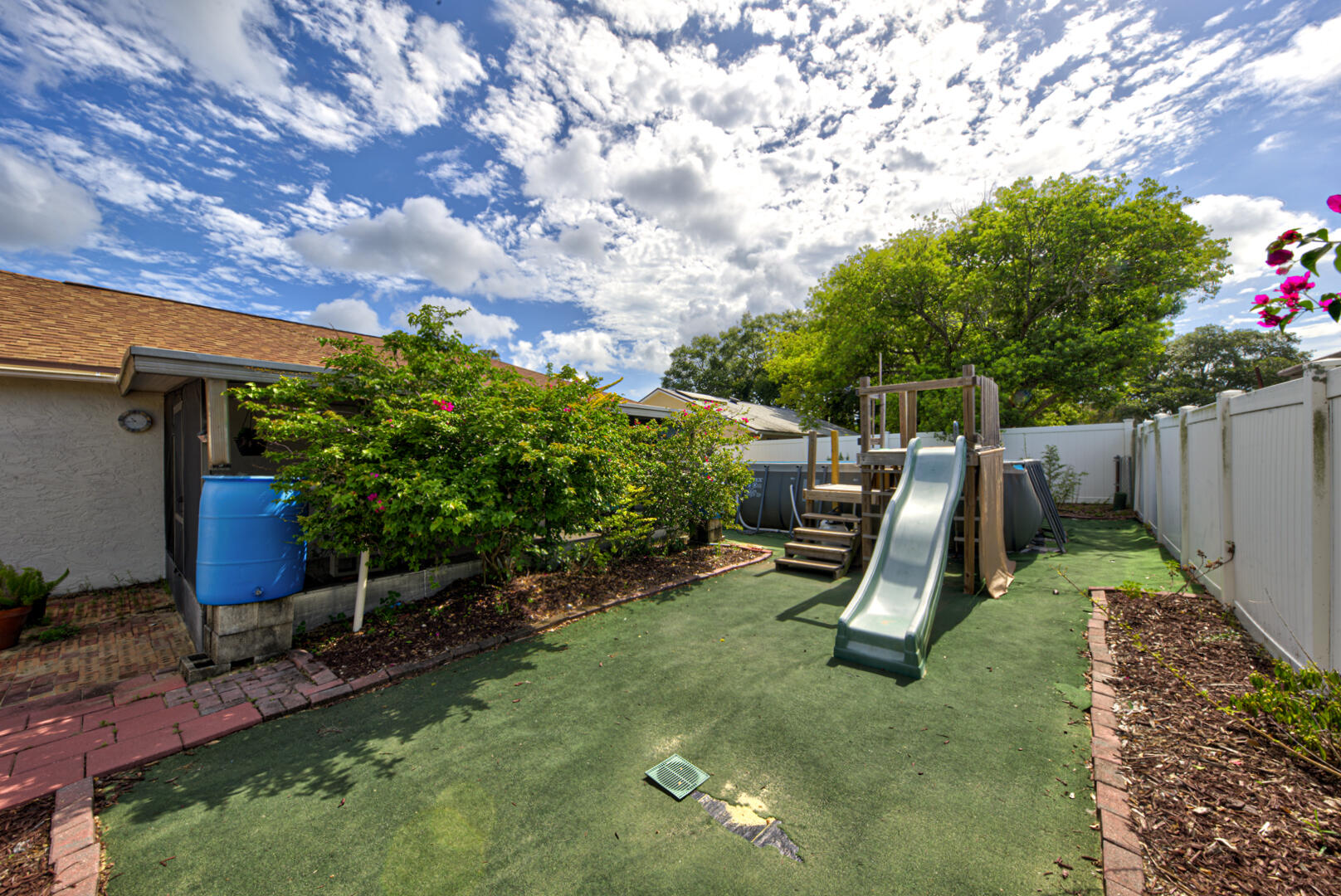2423 Jaywood Road Titusville, FL 32780 - Photo 34 of 37 a view of a backyard with furniture and a slide